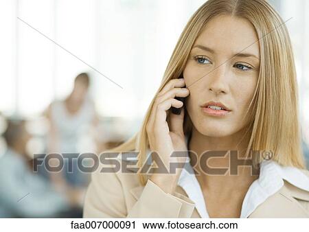 Stock Image - Woman using cell phone. Fotosearch