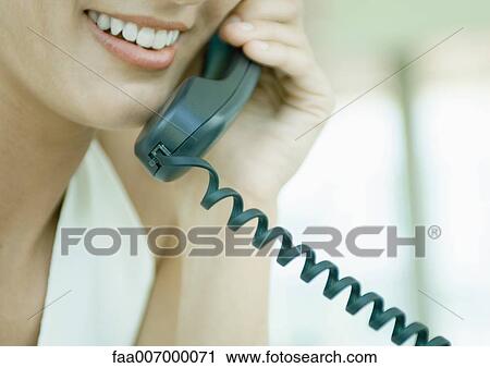Woman using landline phone View Large Photo Image Stock Image - Woman using landline phone. Fotosearch