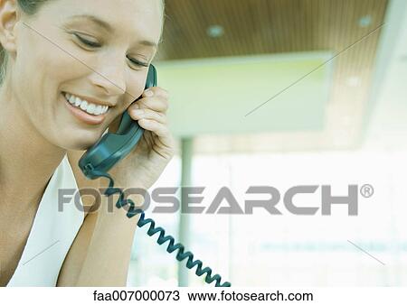 Woman using landline phone View Large Photo Image Stock Image - Woman using landline phone. Fotosearch