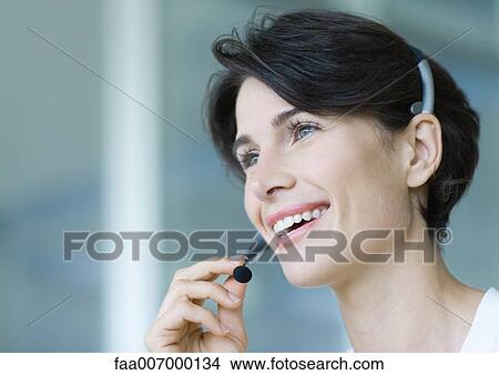 Woman wearing headset View Large Photo Image Picture - Woman wearing headset. Fotosearch