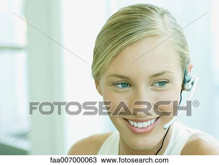 Woman wearing headset View Large Photo Image Stock Image - Woman wearing headset. Fotosearch