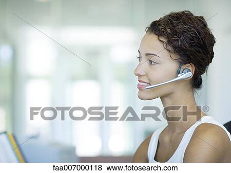 Stock Photo - Woman wearing headset. Fotosearch