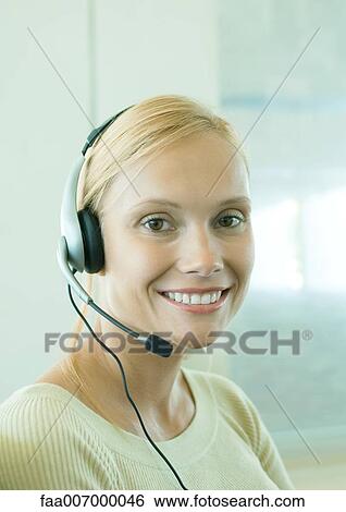 Woman wearing headset View Large Photo Image Stock Photograph - Woman wearing headset. Fotosearch
