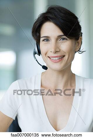 Stock Photography - Woman wearing headset. Fotosearch