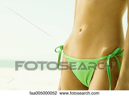 Woman wearing string bikini, close-up of abdomen View Large Photo Image Stock Image - Woman wearing string bikini, close-up of abdomen. Fotosearch