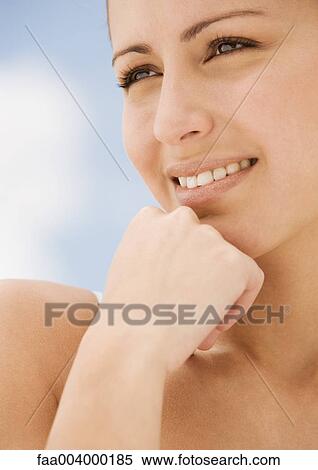 Woman with hand against chin, smiling View Large Photo Image Stock Photography - Woman with hand against chin, smiling. Fotosearch