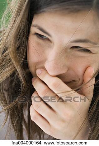Woman with hand over mouth View Large Photo Image Picture - Woman with hand over mouth. Fotosearch