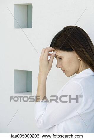 Woman with hand to head, side view View Large Photo Image Stock Image - Woman with hand to head, side view. Fotosearch