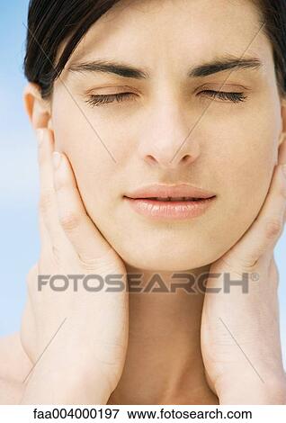 Stock Photo - Woman with hands on neck and eyes closed. Fotosearch