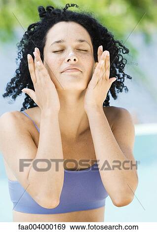 Woman with hands on side of face View Large Photo Image Stock Photo - Woman with hands on side of face. Fotosearch