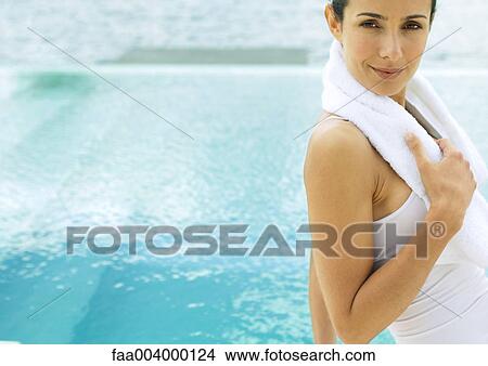 Woman with towel around neck, pool in background View Large Photo Image Picture - Woman with towel around neck, pool in background. Fotosearch