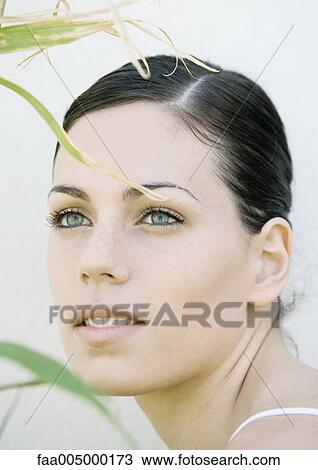 Woman's face, blades of grass in foreground View Large Photo Image Stock Image - Woman's face, blades of grass in foreground. Fotosearch