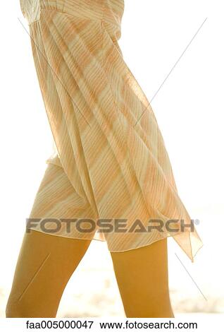 Woman's mid-section, wearing light dress View Large Photo Image Stock Photo - Woman's mid-section, wearing light dress. Fotosearch
