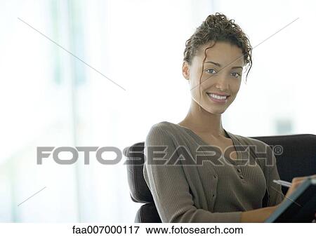 Young businesswoman smiling at camera View Large Photo Image Stock Photo - Young businesswoman smiling at camera. Fotosearch
