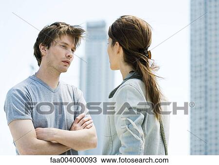 Young couple having argument in front of highrises View Large Photo Image Stock Image - Young couple having argument in front of highrises. Fotosearch