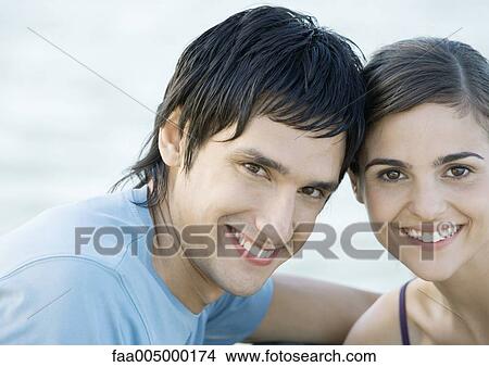 Young couple, head to head, smiling, portrait View Large Photo Image Picture - Young couple, head to head, smiling, portrait. Fotosearch