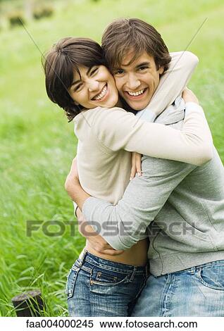 Young couple hugging and smiling View Large Photo Image Stock Photography - Young couple hugging and smiling. Fotosearch