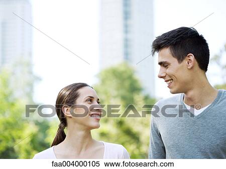 Young couple smiling at each other View Large Photo Image Stock Photography - Young couple smiling at each other. Fotosearch