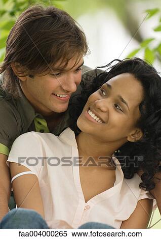 Young couple smiling at each other View Large Photo Image Stock Photography - Young couple smiling at each other. Fotosearch