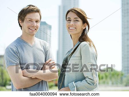 Young couple smiling in urban area View Large Photo Image Picture - Young couple smiling in urban area. Fotosearch
