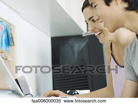 Young couple using computer View Large Photo Image Stock Photography - Young couple using computer. Fotosearch
