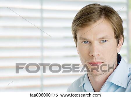 Young man looking at camera, portrait View Large Photo Image Stock Photography - Young man looking at camera, portrait. Fotosearch