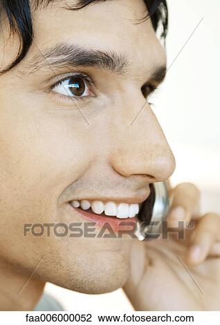Young man using cell phone, extreme close-up View Large Photo Image Stock Image - Young man using cell phone, extreme close-up. Fotosearch