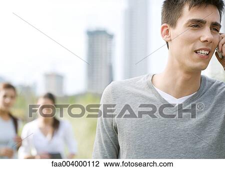 Young man using cell phone View Large Photo Image Stock Image - Young man using cell phone . Fotosearch