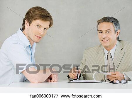Young man with mature businessman, smiling at camera View Large Photo Image Stock Photo - Young man with mature businessman, smiling at camera. Fotosearch