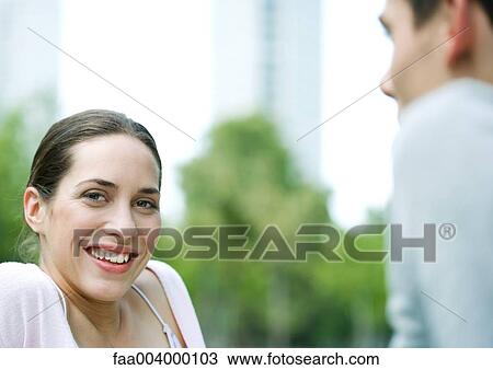 Young woman smiling at camera View Large Photo Image Stock Image - Young woman smiling at camera. Fotosearch