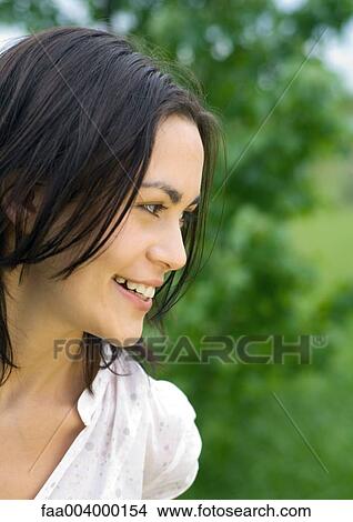 Young woman smiling, partial view View Large Photo Image Picture - Young woman smiling, partial view. Fotosearch