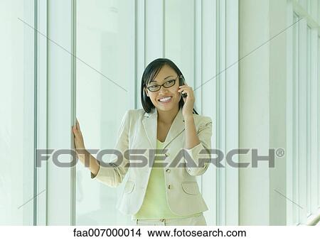 Picture - Young woman using cell phone. Fotosearch