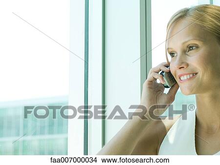 Young woman using cell phone View Large Photo Image Picture - Young woman using cell phone. Fotosearch