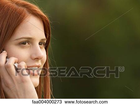 Young woman using cell phone View Large Photo Image Stock Image - Young woman using cell phone. Fotosearch
