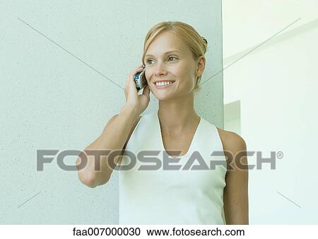 Young woman using cell phone View Large Photo Image Stock Image - Young woman using cell phone. Fotosearch