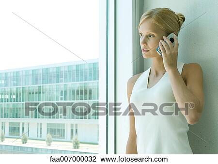 Young woman using cell phone View Large Photo Image Stock Image - Young woman using cell phone. Fotosearch