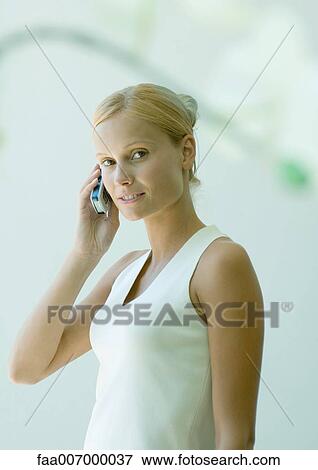 Young woman using cell phone View Large Photo Image Stock Photo - Young woman using cell phone. Fotosearch