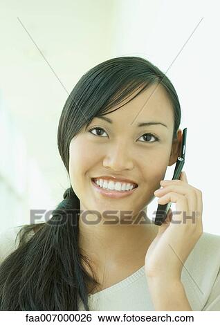 Young woman using cell phone View Large Photo Image Stock Photograph - Young woman using cell phone. Fotosearch