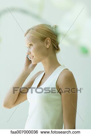 Young woman using cell phone View Large Photo Image Stock Photograph - Young woman using cell phone. Fotosearch