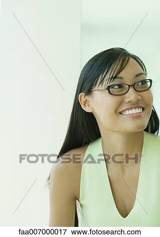Stock Photo - Young woman wearing glasses, portrait. Fotosearch