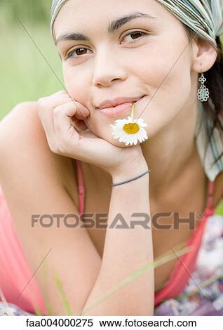 Young woman with flower in mouth, portrait View Large Photo Image Stock Photography - Young woman with flower in mouth, portrait. Fotosearch