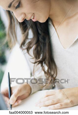 Young woman writing, close-up View Large Photo Image Stock Image - Young woman writing, close-up. Fotosearch