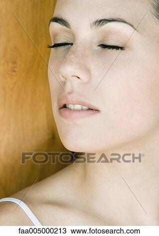 Young woman's face with eyes shut, close-up View Large Photo Image Stock Image - Young woman's face with eyes shut, close-up. Fotosearch