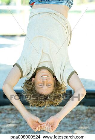 Boy hanging upside down View Large Photo Image Picture - Boy hanging upside down. Fotosearch