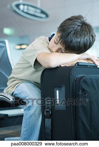 Boy resting head on suitcase, sleeping View Large Photo Image Stock Photo - Boy resting head on suitcase, sleeping. Fotosearch