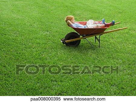 Boy sleeping in wheelbarrow View Large Photo Image Stock Photography - Boy sleeping in wheelbarrow. Fotosearch