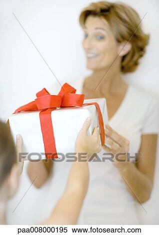 Child handing woman gift View Large Photo Image Stock Photography - Child handing woman gift. Fotosearch