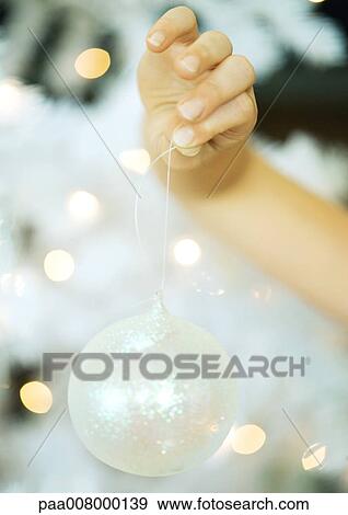 Child holding up ornament View Large Photo Image Stock Photo - Child holding up ornament. Fotosearch