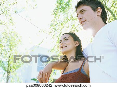 Couple walking in residential area View Large Photo Image Stock Image - Couple walking in residential area. Fotosearch