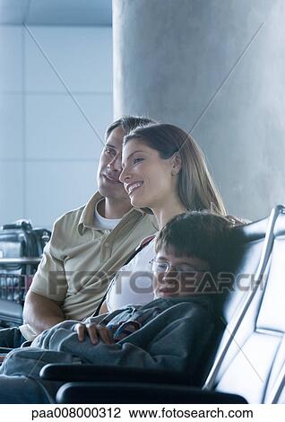 Family sitting in airport lounge, boy sleeping View Large Photo Image Stock Image - Family sitting in airport lounge, boy sleeping. Fotosearch